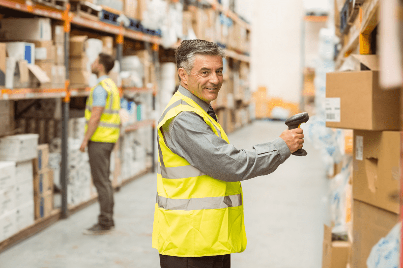 A warehouse worker efficiently managing inventory by using a handheld barcode scanner to scan items in a large storage facility 